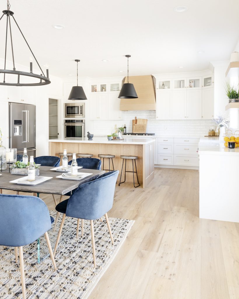 A stylish kitchen and dining room with elegant blue chairs