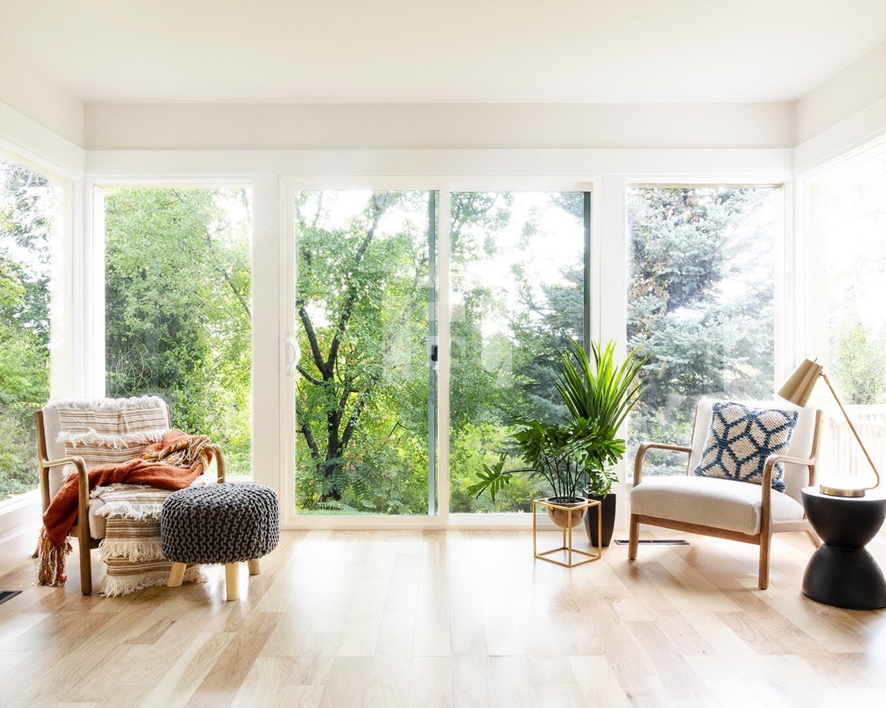 A cozy living room with a patterned rug and comfortable chairs.