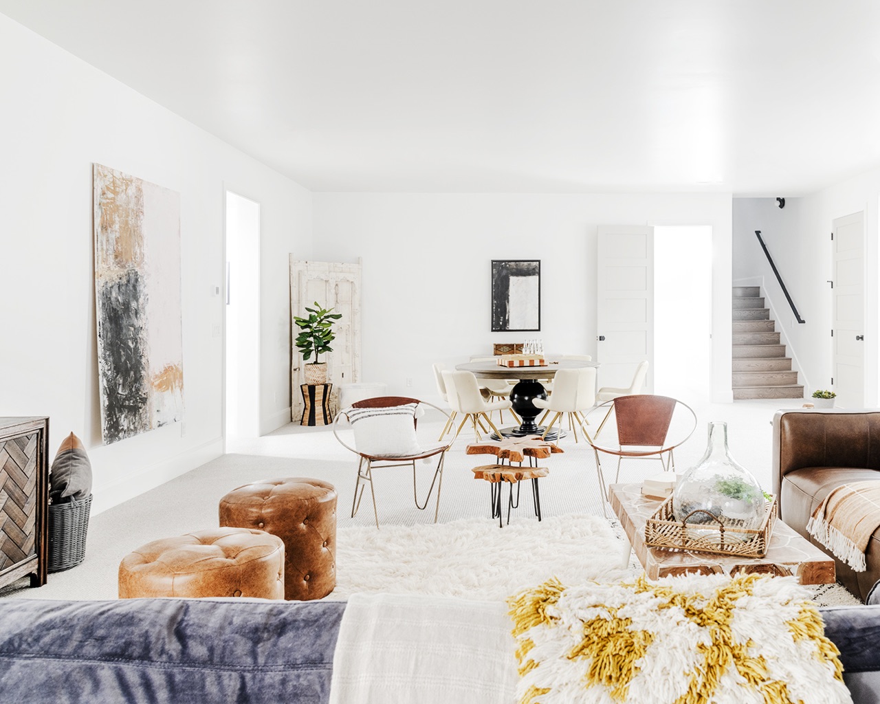 White-themed living room with modern furniture and minimalist decor.