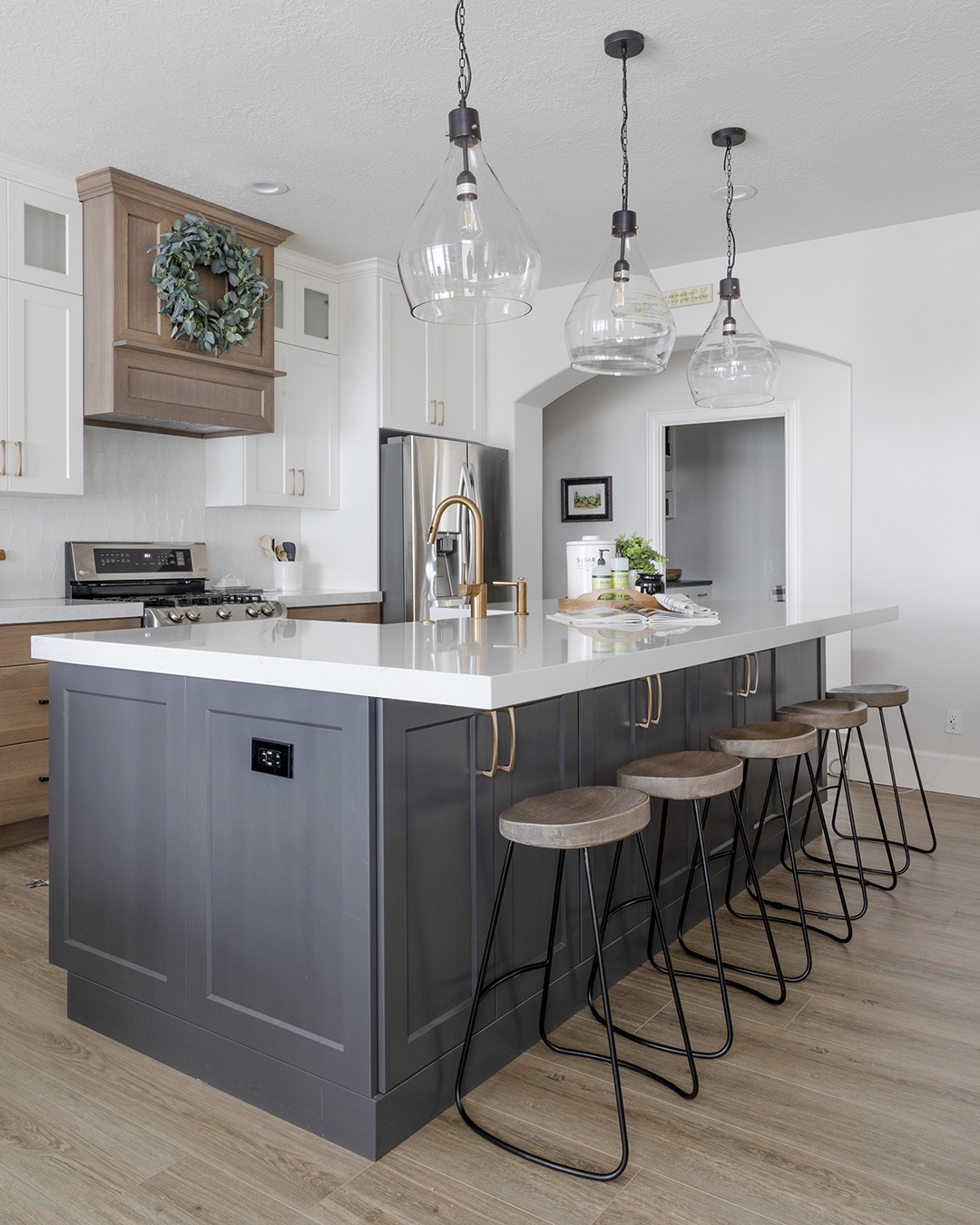 Kitchen with spacious island and bar stools.