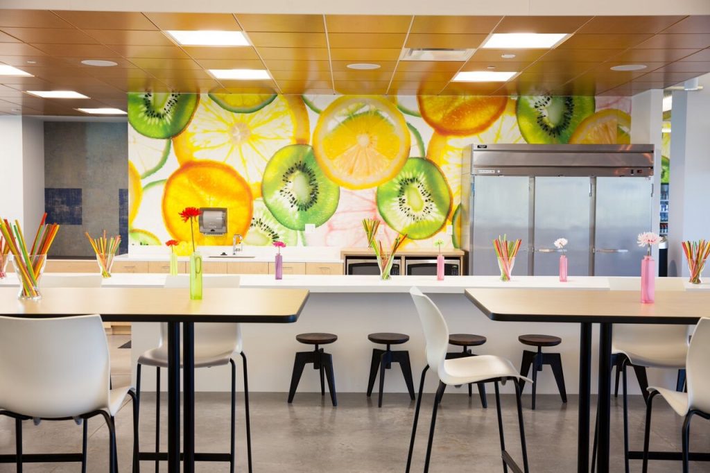 A kitchen with a colorful fruit mural on the wall, adding a vibrant and refreshing touch to the space.