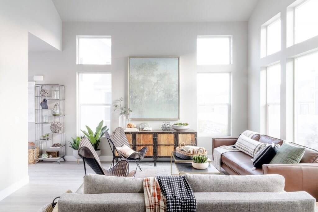 A well-lit living room with ample windows, showcasing a tidy and organized space.