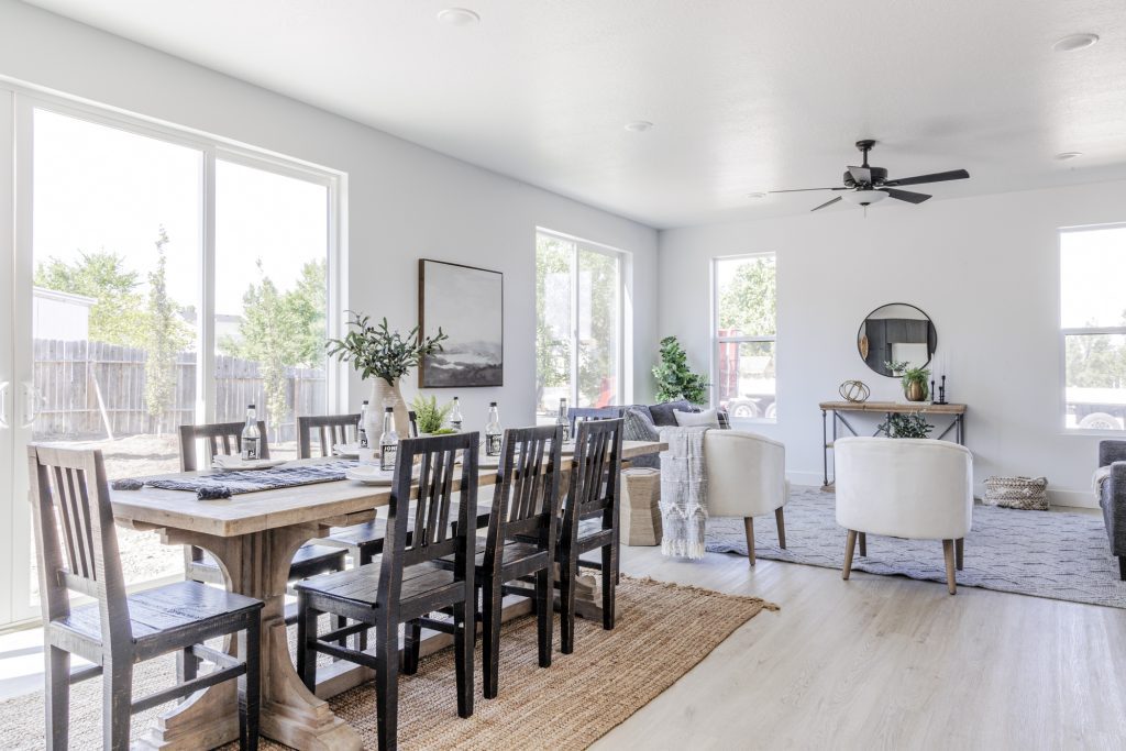 A dining room with a wooden table and four chairs.