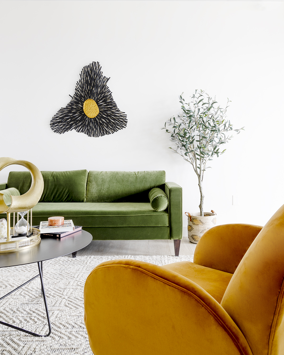 A cozy living room with a green couch, yellow chair, and a coffee table.