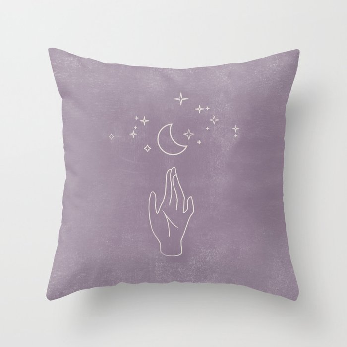 Purple pillow with moon and hand design, perfect for adding a mystical touch to your home decor.