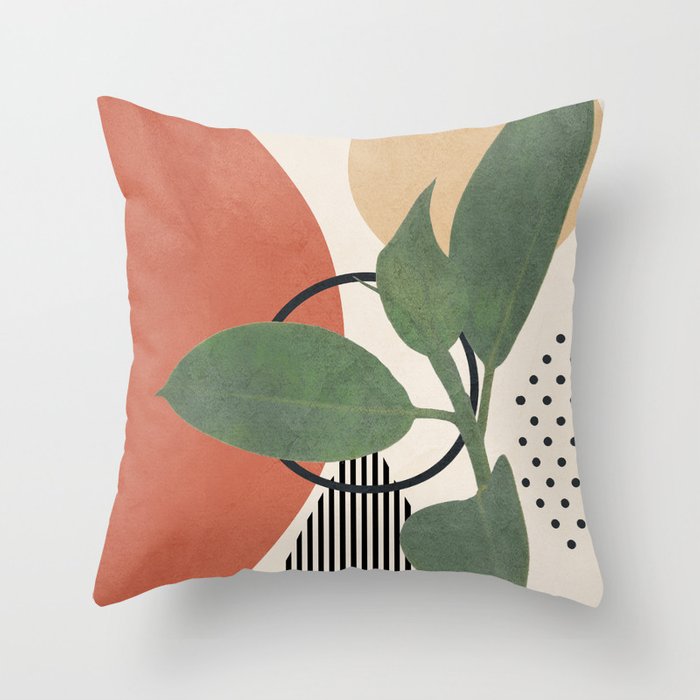 A decorative pillow with a small plant and geometric designs.