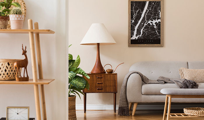 A cozy living room with a comfortable couch, a stylish lamp, and a beautiful painting on the wall.