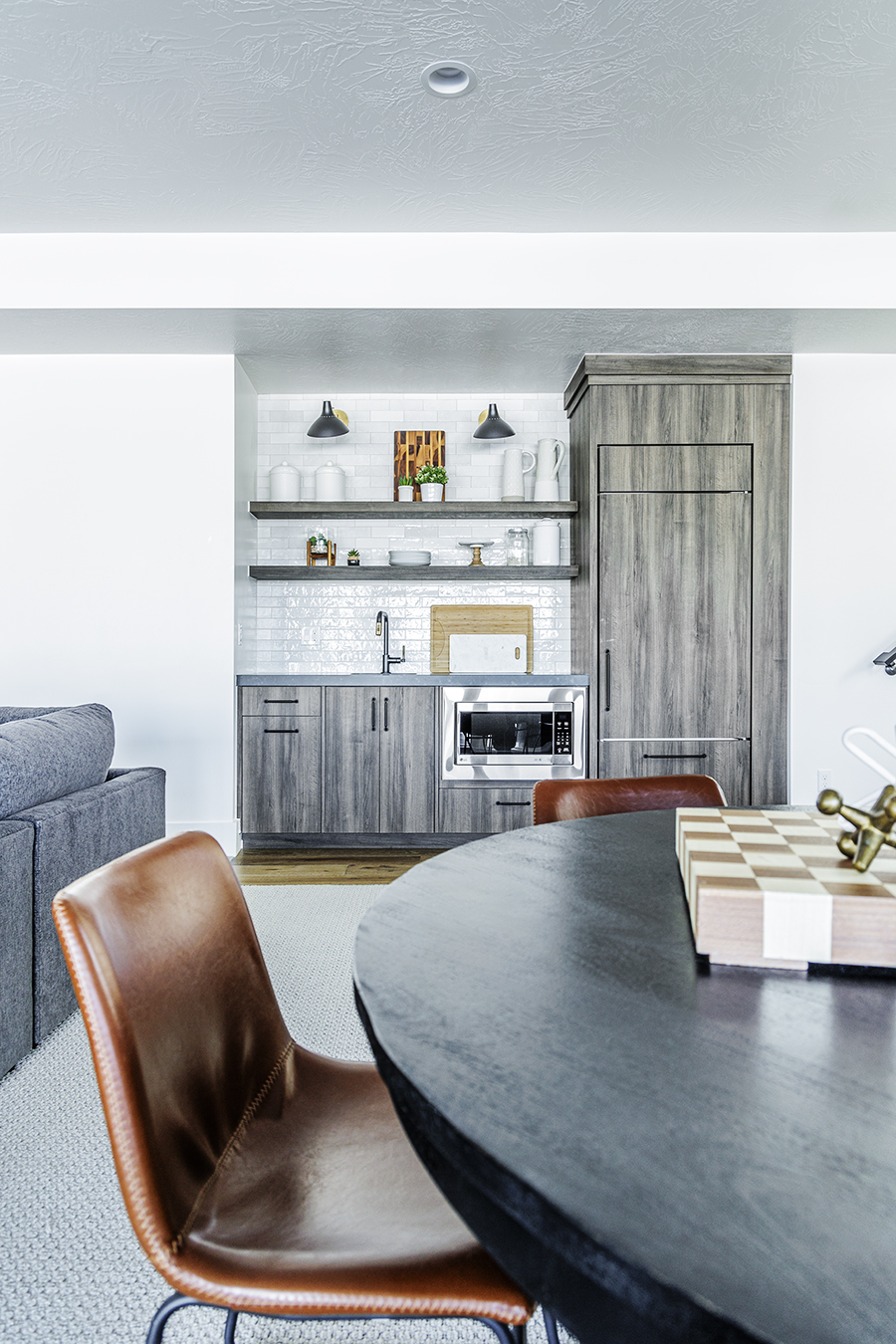 A dining room with a table, chairs, and a cabinet.